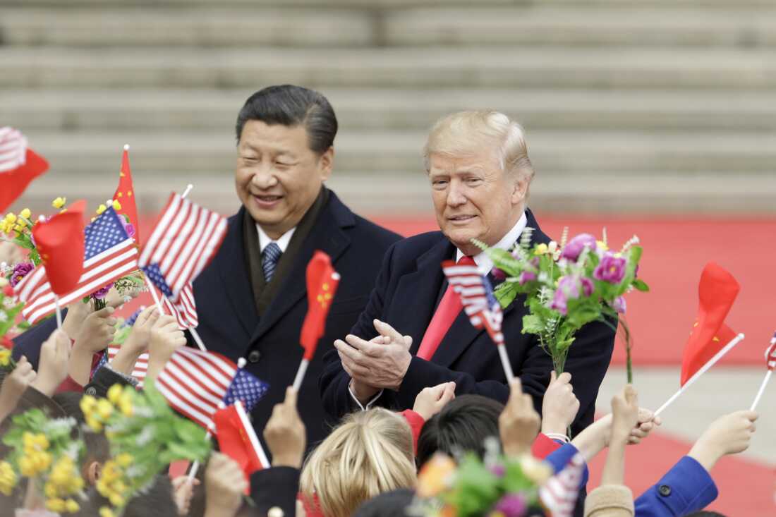 FILE: Bloomberg Best of US President Donald Trump 2017 - 2020: US President Donald Trump, right, and Xi Jinping, president of China, greet attendees waving flags of America and China during a reception outside the Great Hall of the People in Beijing, China. , on Thursday, Nov. 9, 2017. Our editors select the best archival images looking back at Trumps 4 years from 2017 - 2020. Photographer: Qilai Shen/Bloomberg via Getty Images