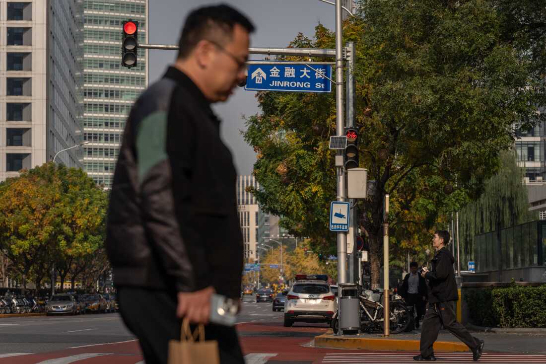 Pedestrians cross the street on Financial Street in Beijing, China, on Thursday. When Donald Trump started a trade war with China in 2018, Beijing found itself on the back foot and unsure how to respond. This time President Xi Jinping is better prepared for battle, although he has a lot to throw at him. Photo credit: Na Bian/Bloomberg via Getty Images